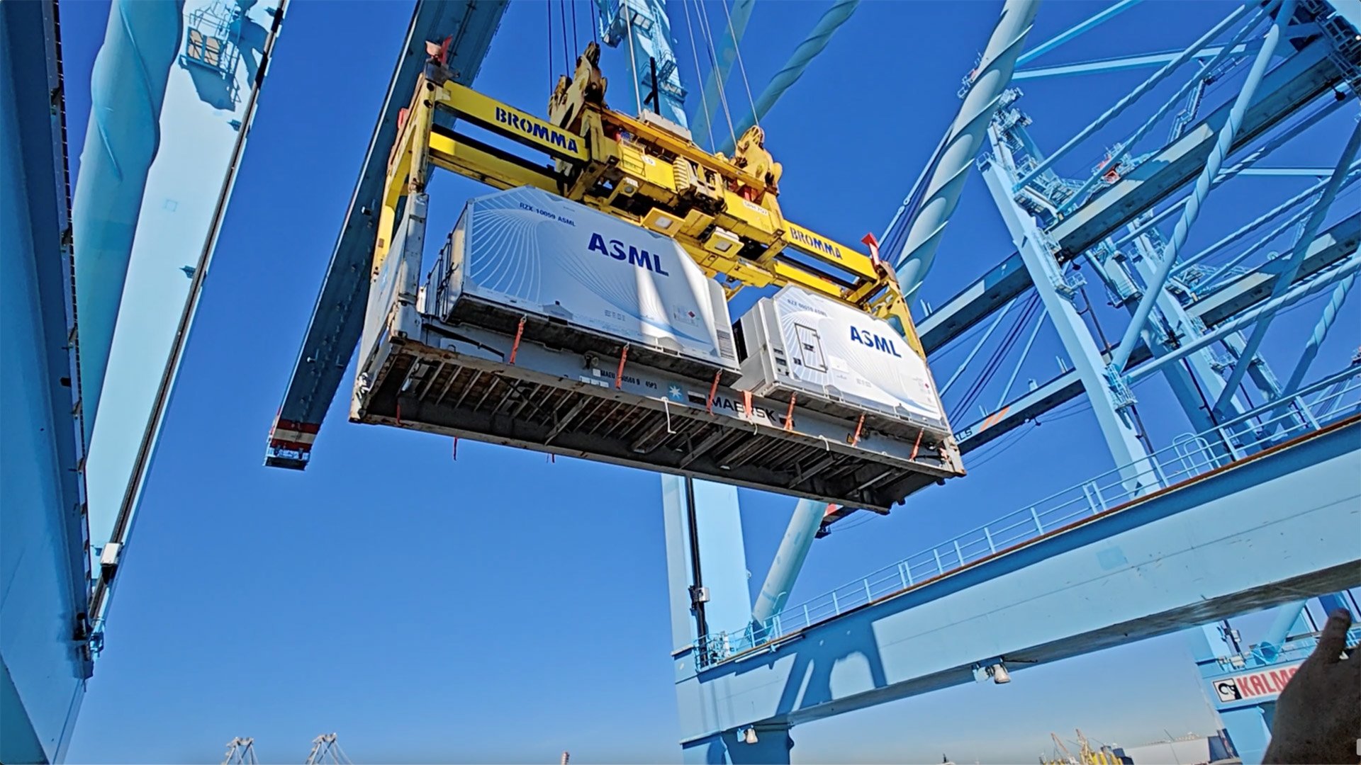 ASML equipment being lifted by a crane at an industrial site